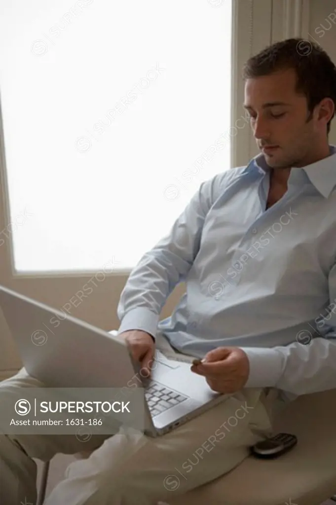 Close-up of a young man using a laptop
