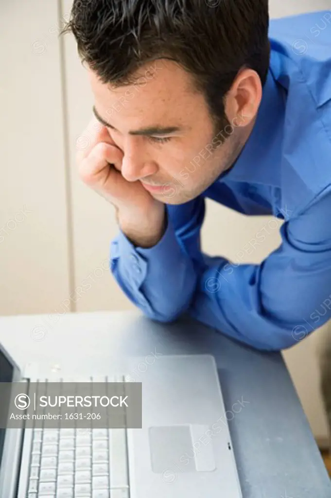 Close-up of a businessman looking at a laptop