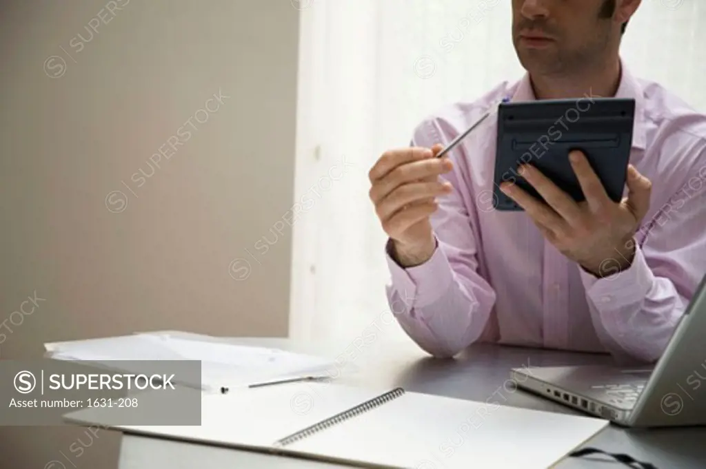 Close-up of a businessman using an electronic organizer