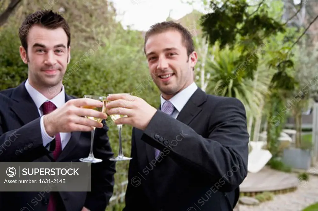 Portrait of two businessmen toasting with wineglasses