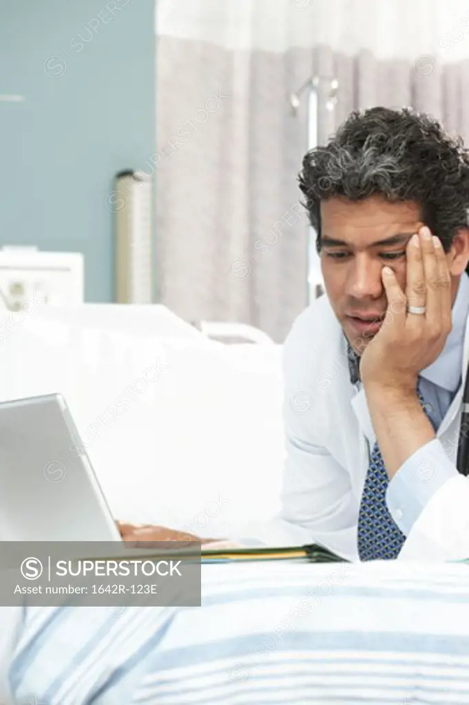 Close-up of a male doctor using a laptop