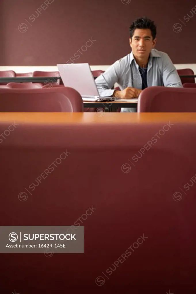 Portrait of a college student sitting in a lecture hall