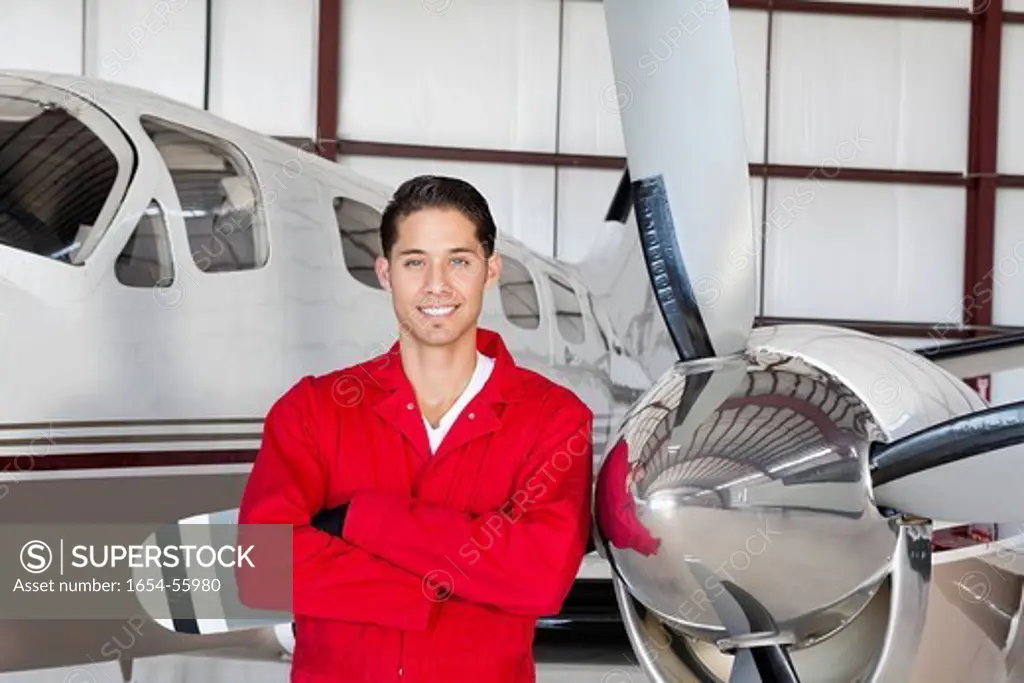 Palm Springs, California, USA. Portrait of young aeronautic engineer standing in front of airplane