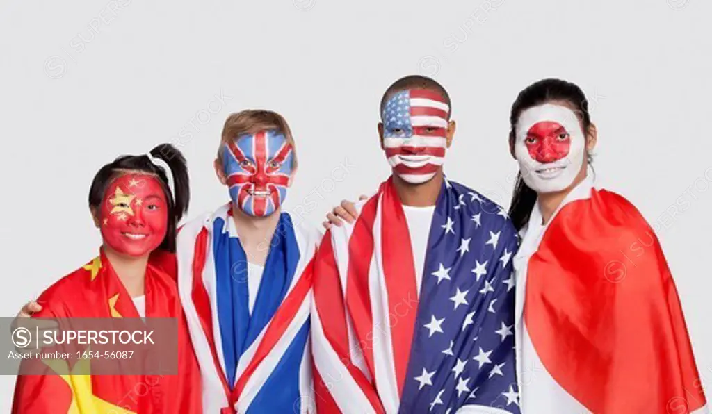 London, UK. Portrait of multi_ethnic group with national flags and face painting against white background