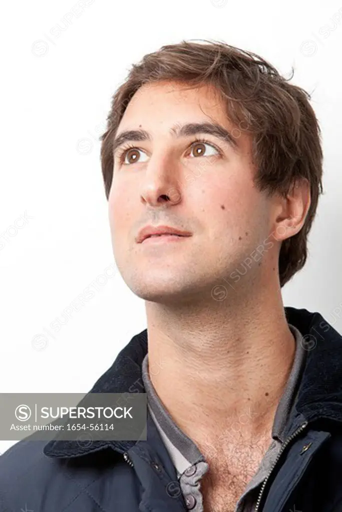 London, UK. Handsome young Middle Eastern man looking away against white background