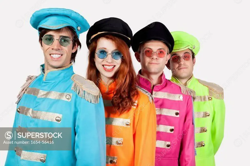 London, UK. Portrait of young marching band members in colorful clothing against gray background
