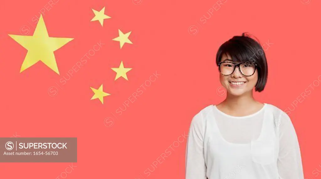 London, UK. Portrait of happy young woman wearing eyeglasses against Chinese flag