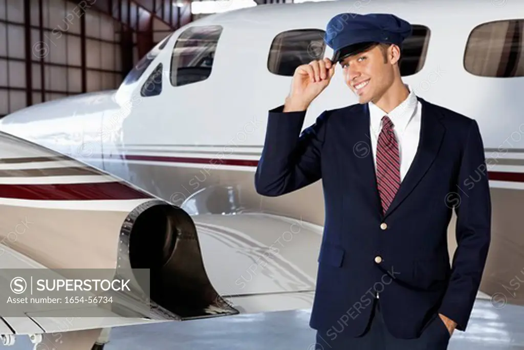 Palm Springs, California, USA. Portrait of handsome young pilot standing in front of private airplane
