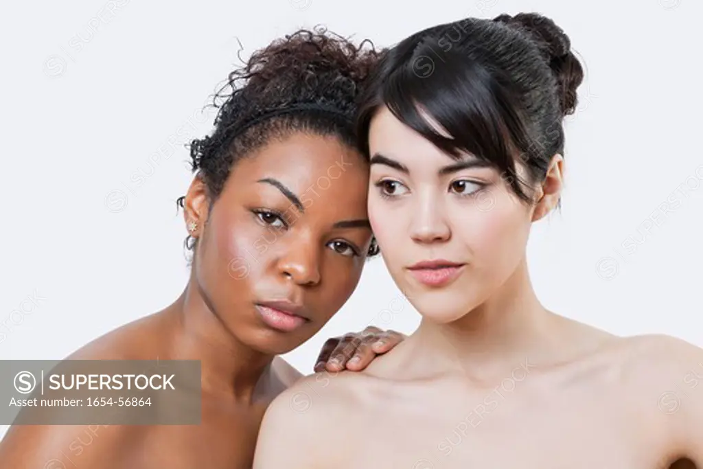 London, UK. Beauty portrait of young multi_ethnic women over white background