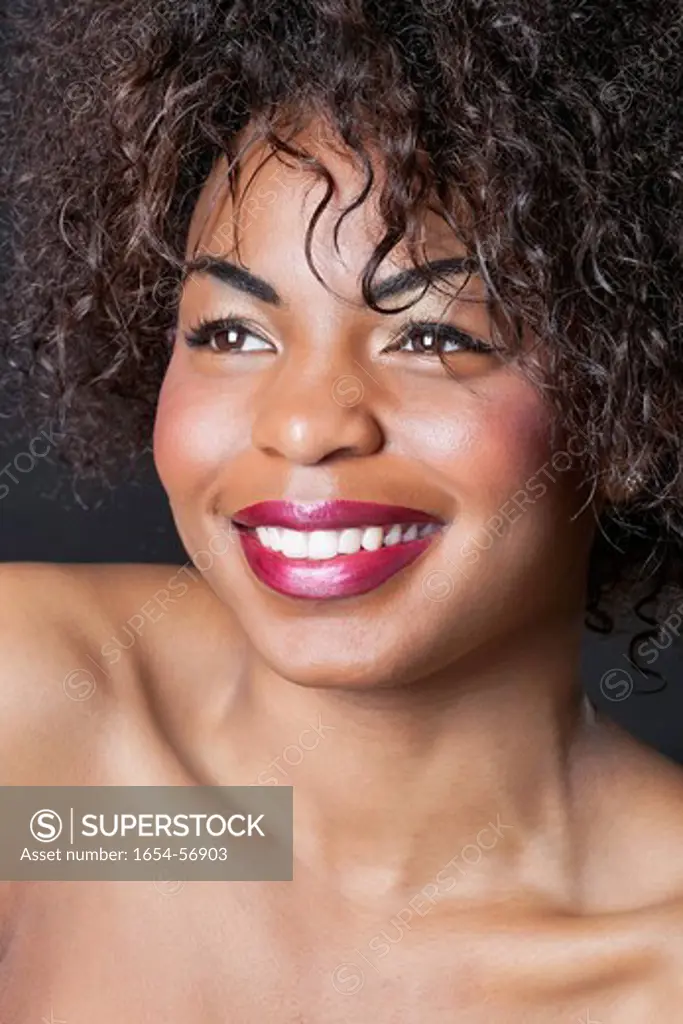 London, UK. Extreme close_up of smiling young African American woman