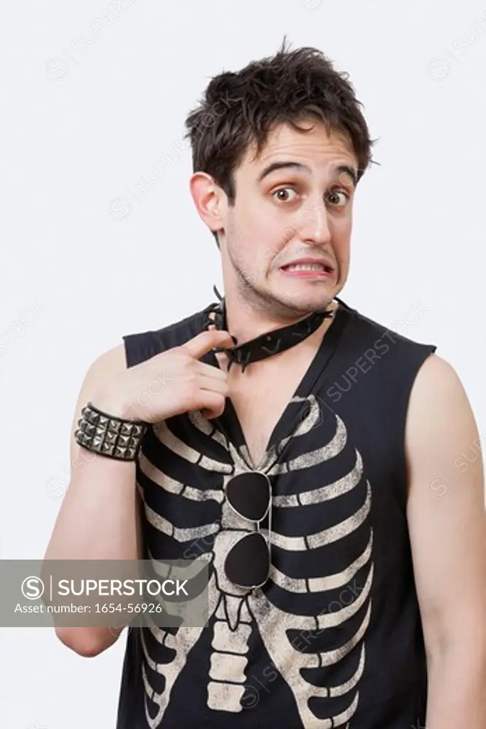 London, UK. Portrait of displeased young punk man over white background