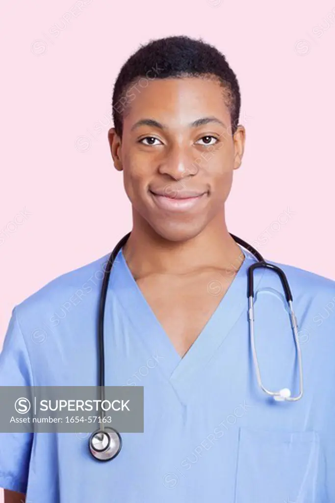 London, UK. Portrait of mixed race male surgeon over pink background