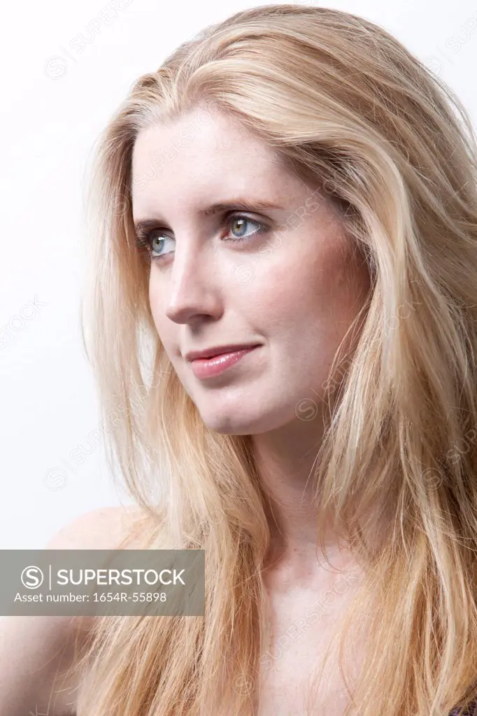 Thoughtful young woman looking away against white background