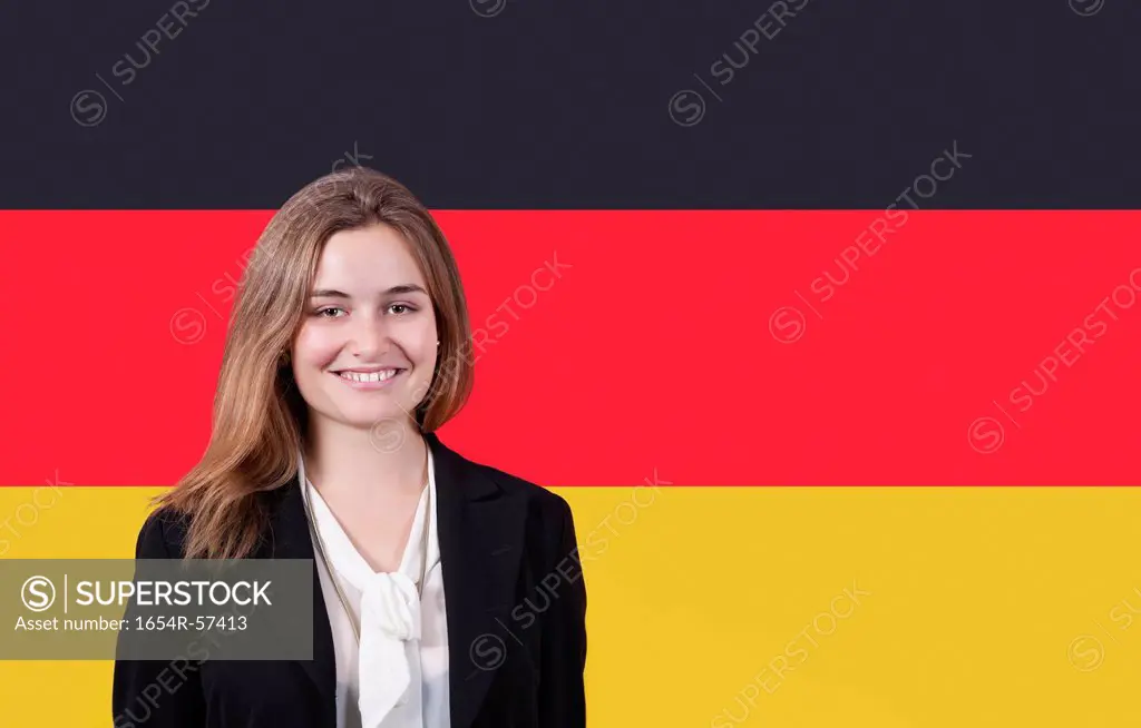 Portrait of young businesswoman smiling over German flag