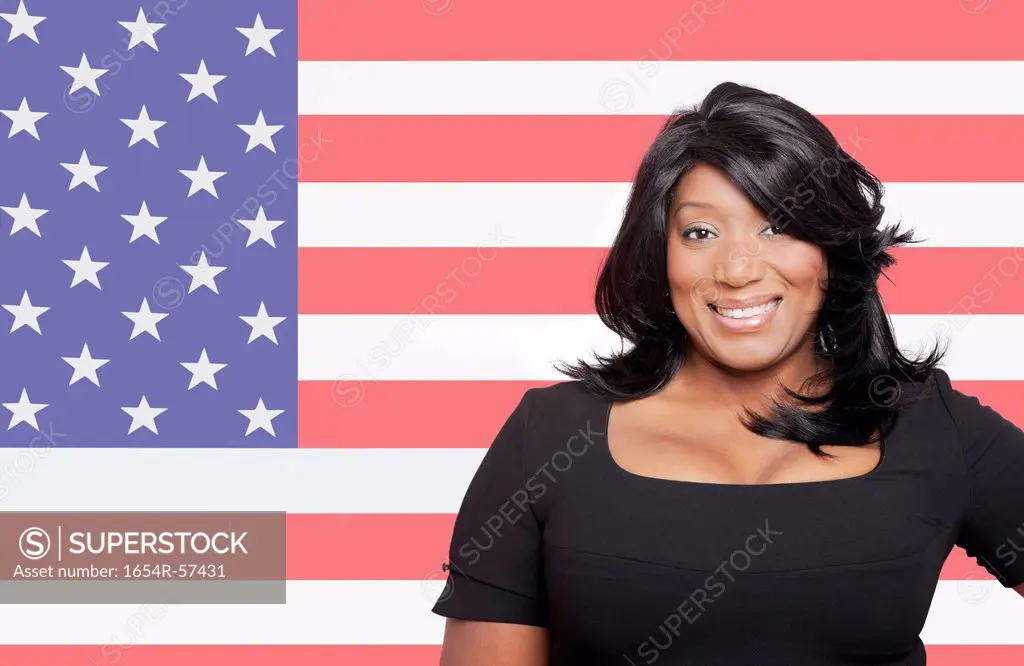Portrait of casual mixed race woman against American flag