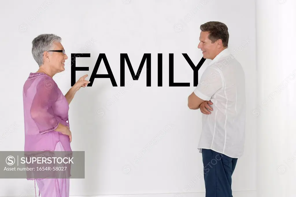 Couple discussing family issues against white wall with English text