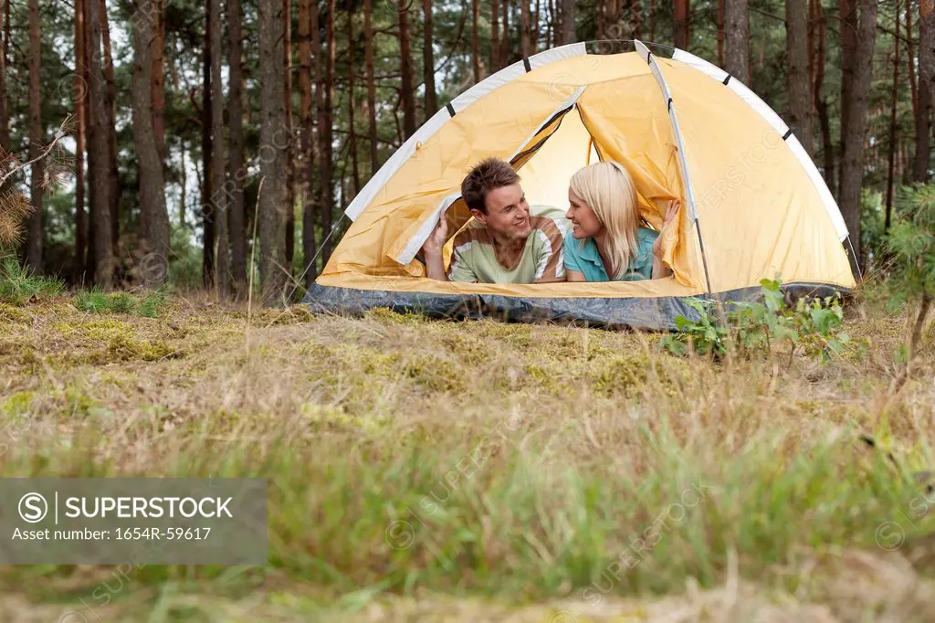 Loving young couple relaxing in tent