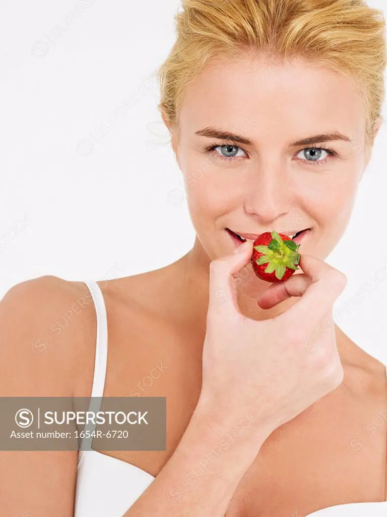 Young Woman in underwear Eating Strawberry portrait