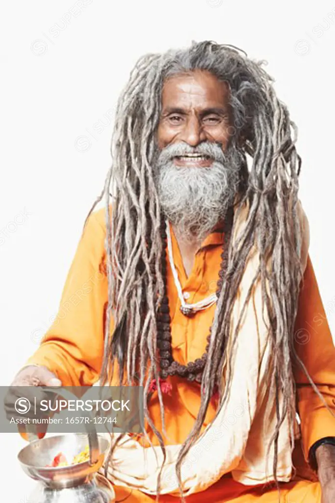 Portrait of a sadhu holding a kamandal and smiling