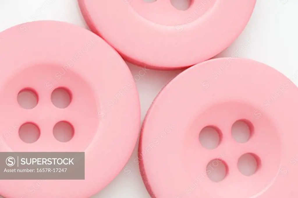 Close-up of three pink buttons