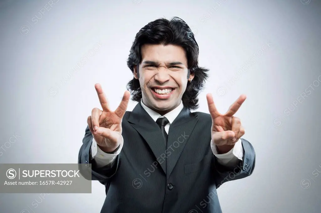Businessman showing victory sign with his both hands