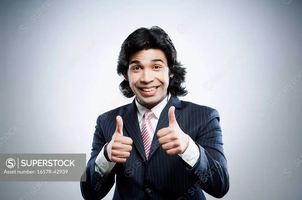 Happy businessman showing thumbs up sign