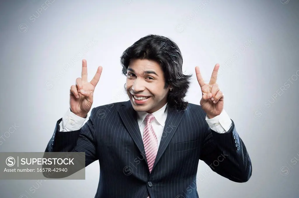 Businessman showing victory sign with his both hands