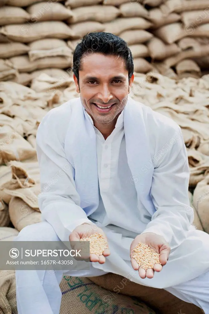 Man showing wheat grains, Anaj Mandi, Sohna, Gurgaon, Haryana, India