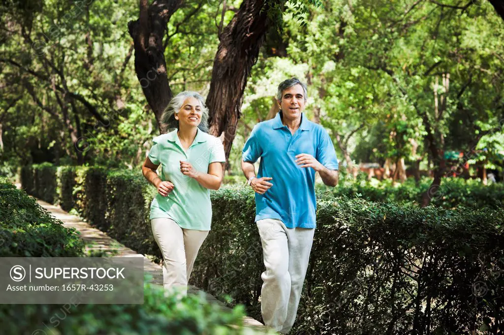 Mature couple jogging in a park, Lodi Gardens, New Delhi, India