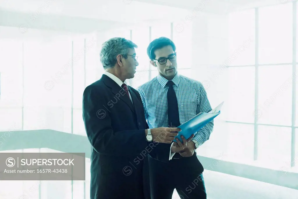 Business men discussing a document