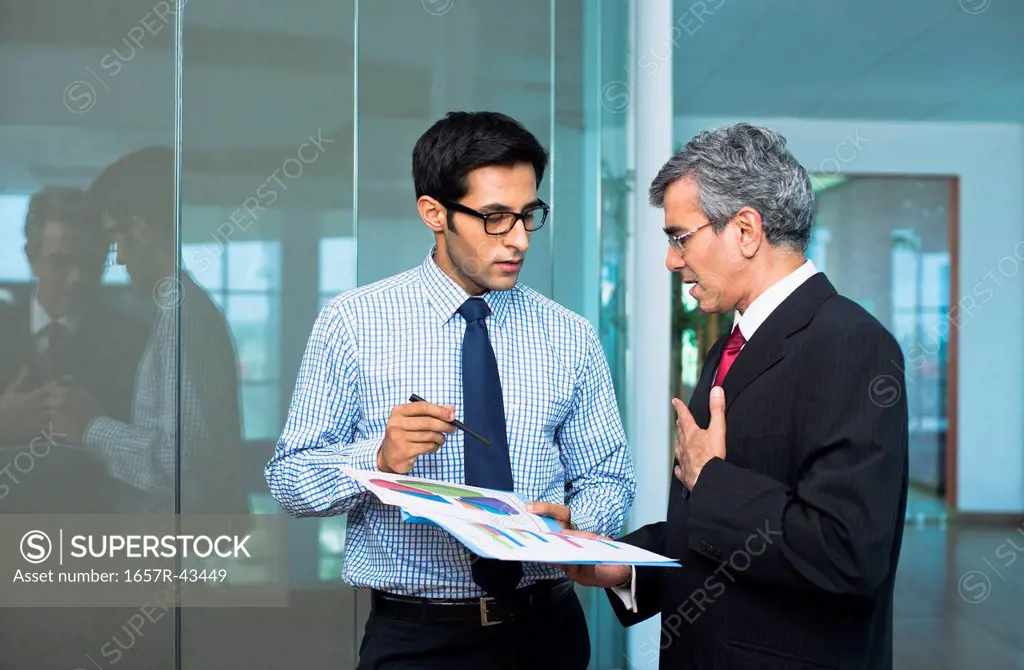 Businessmen discussing a report