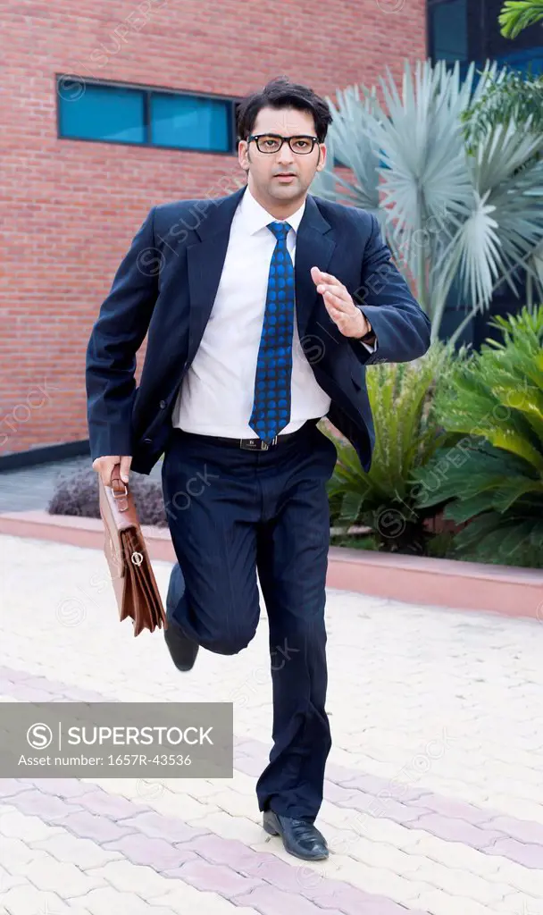 Businessman running with briefcase