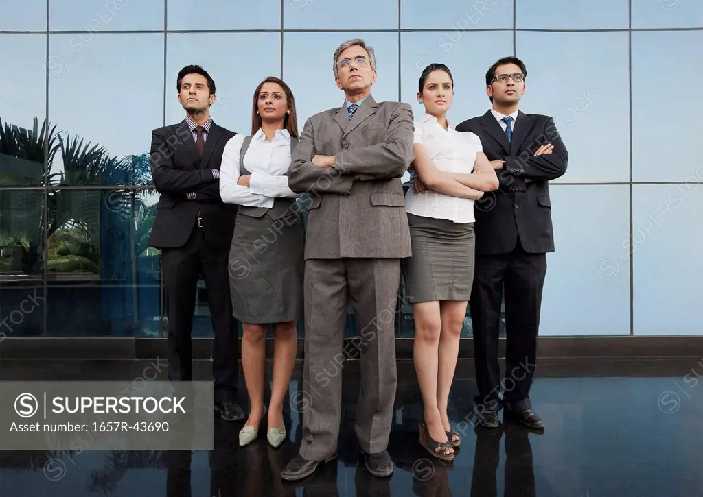 Business people standing together with their arms crossed