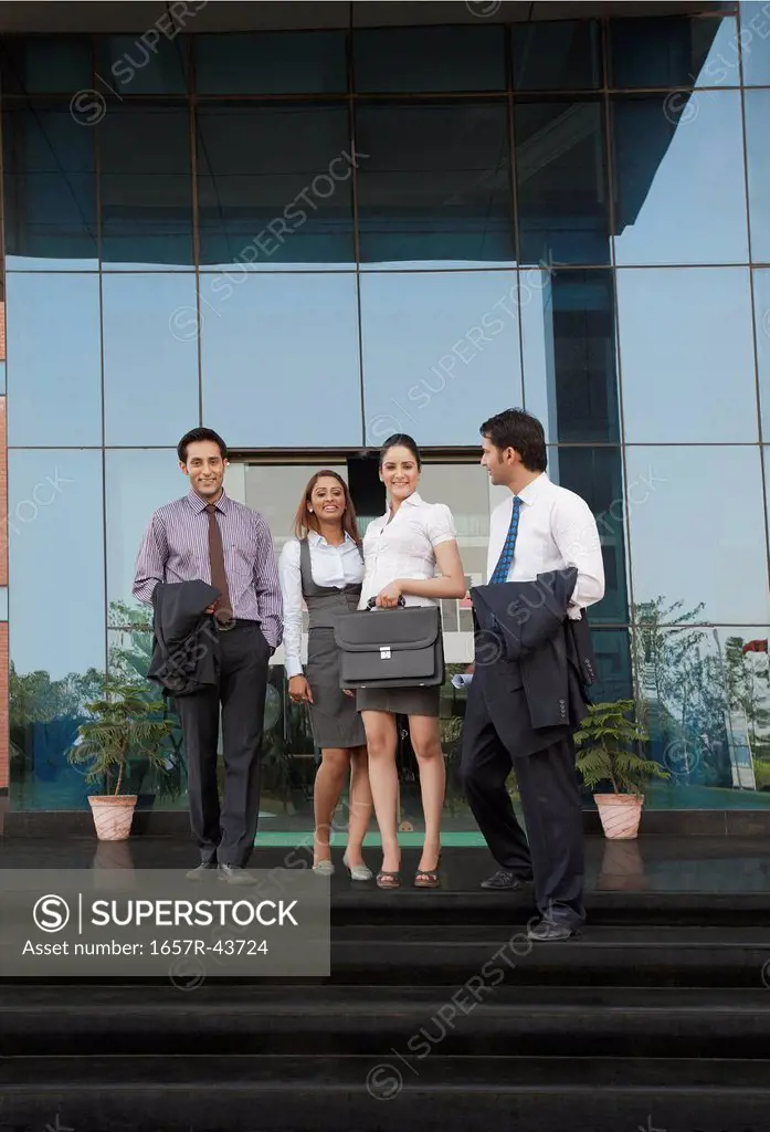 Business people moving down steps