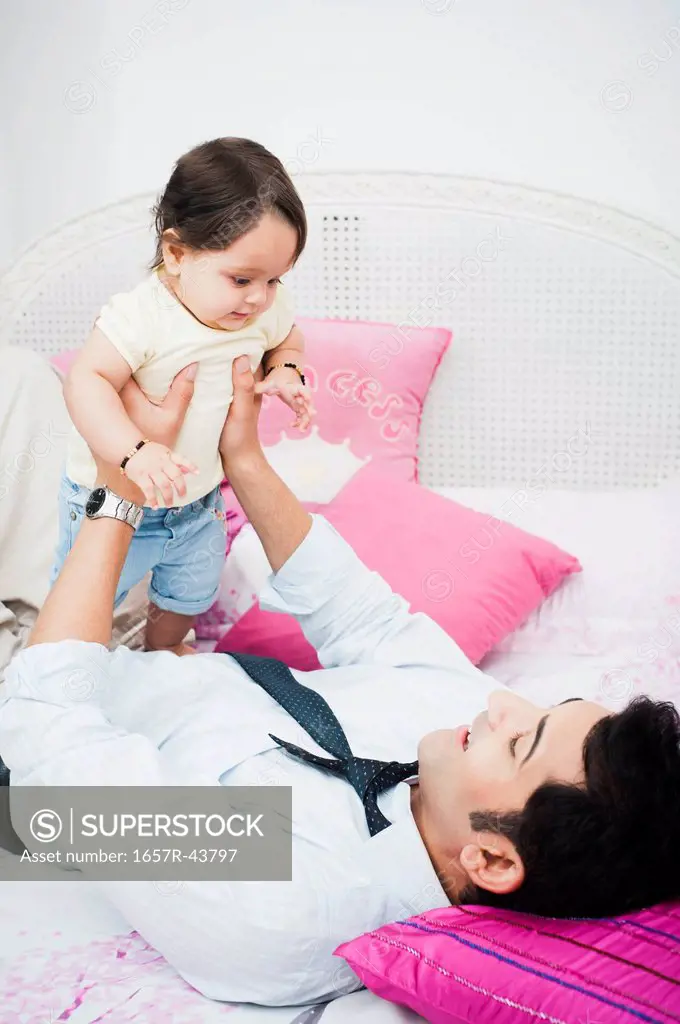 Businessman playing with his baby