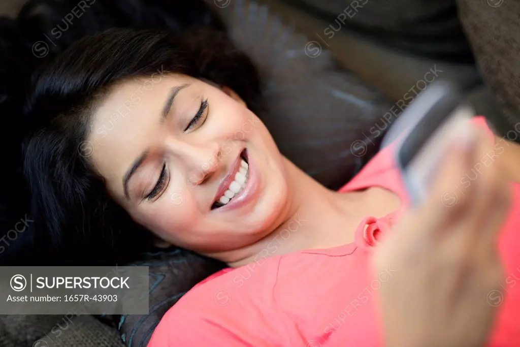 Woman text messaging on a mobile phone
