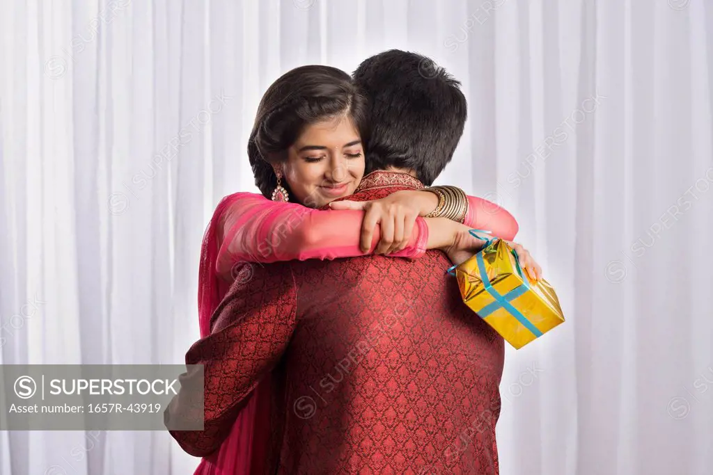 Teenage girl hugging her brother at Raksha Bandhan