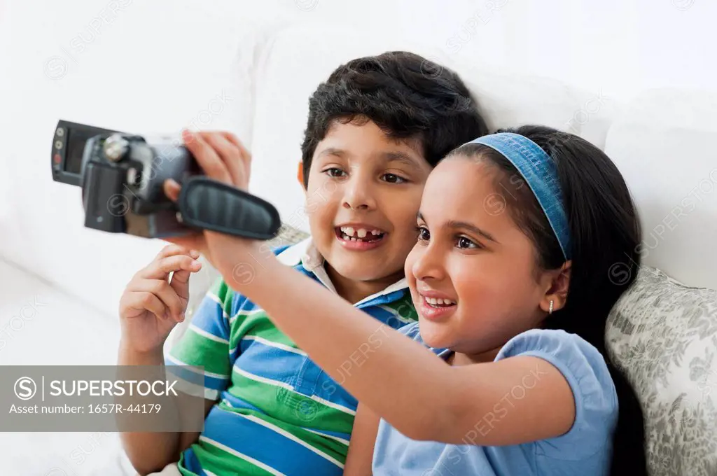 Children filming themselves with a video camera