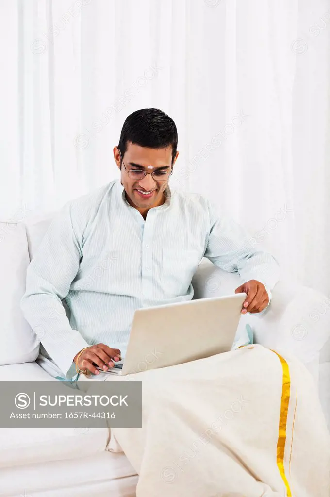South Indian man using a laptop