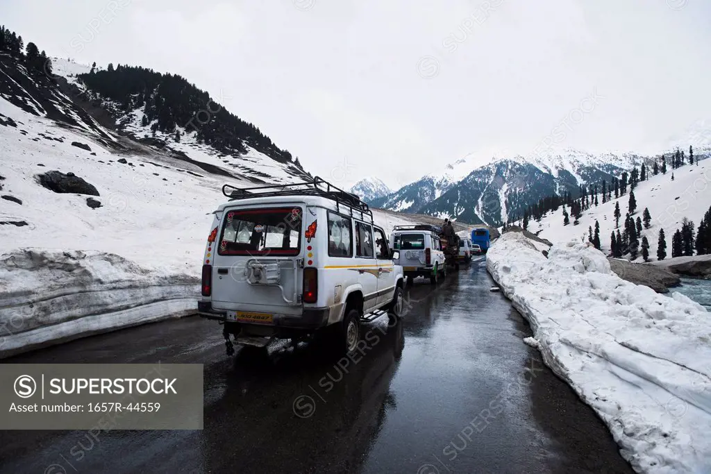 Cars moving on the road in snowy valley, Sonmarg, Jammu And Kashmir, India