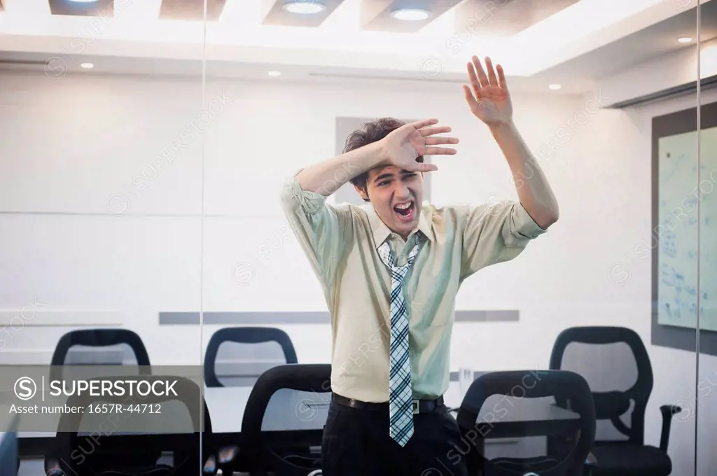 Businessman shouting behind from a glass door