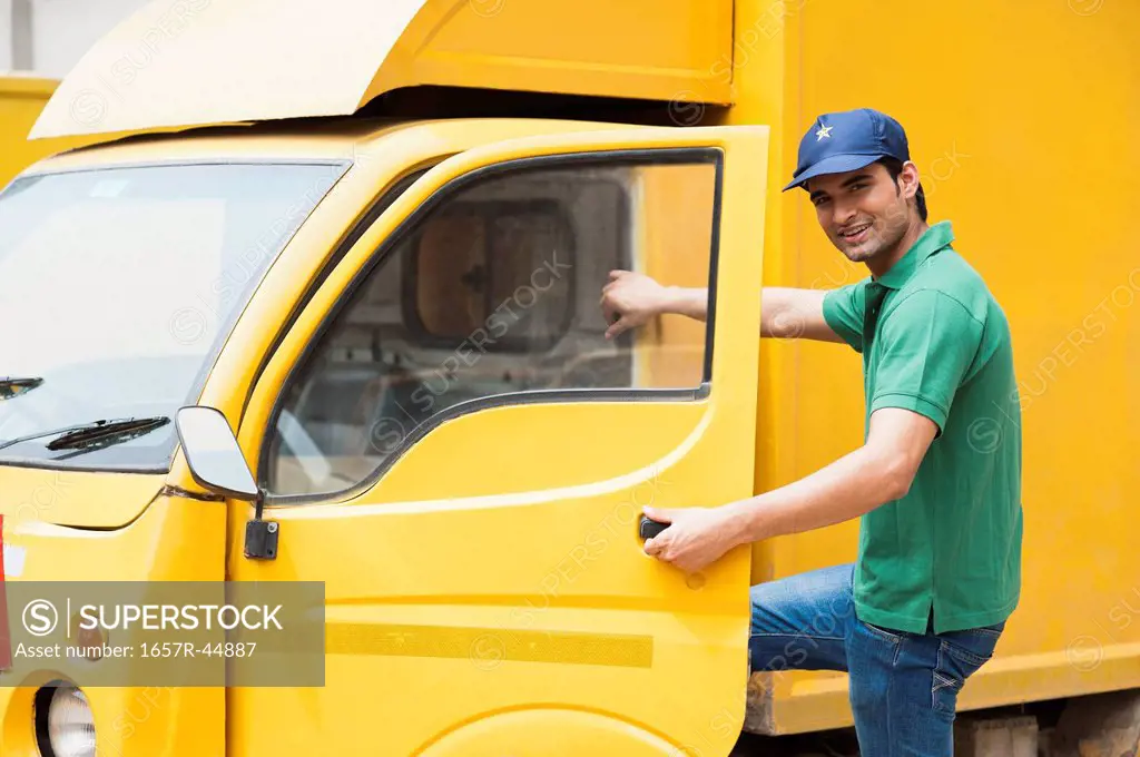 Delivery man opening the door of a van