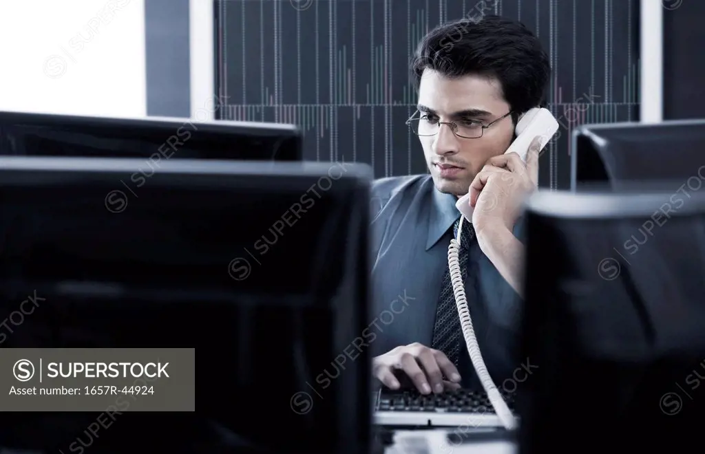 Businessman talking on a landline phone