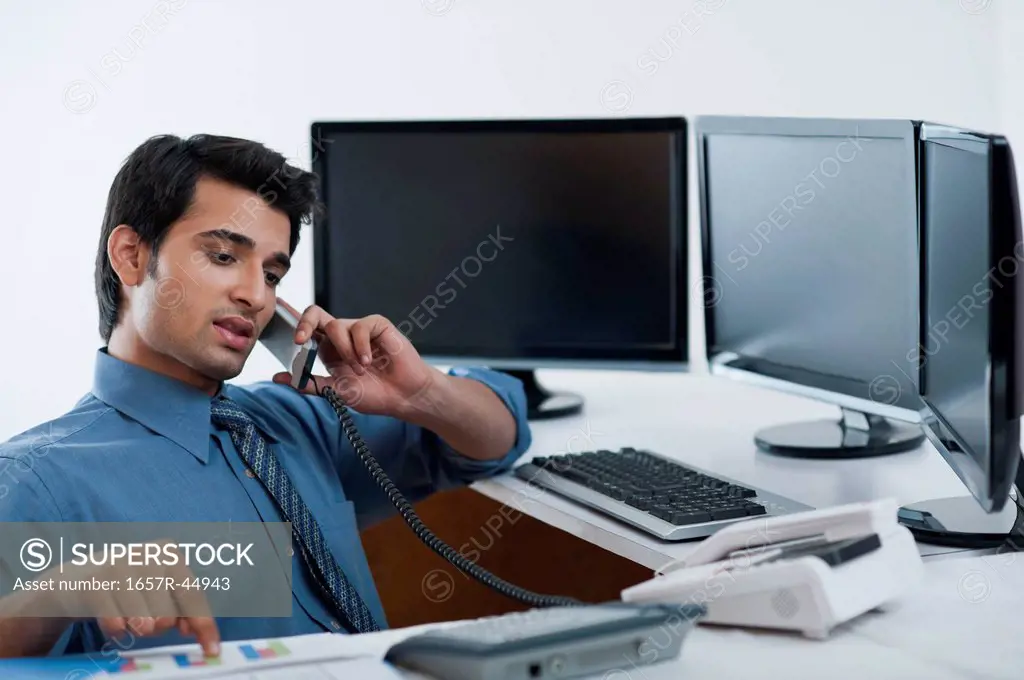 Businessman talking on a landline phone