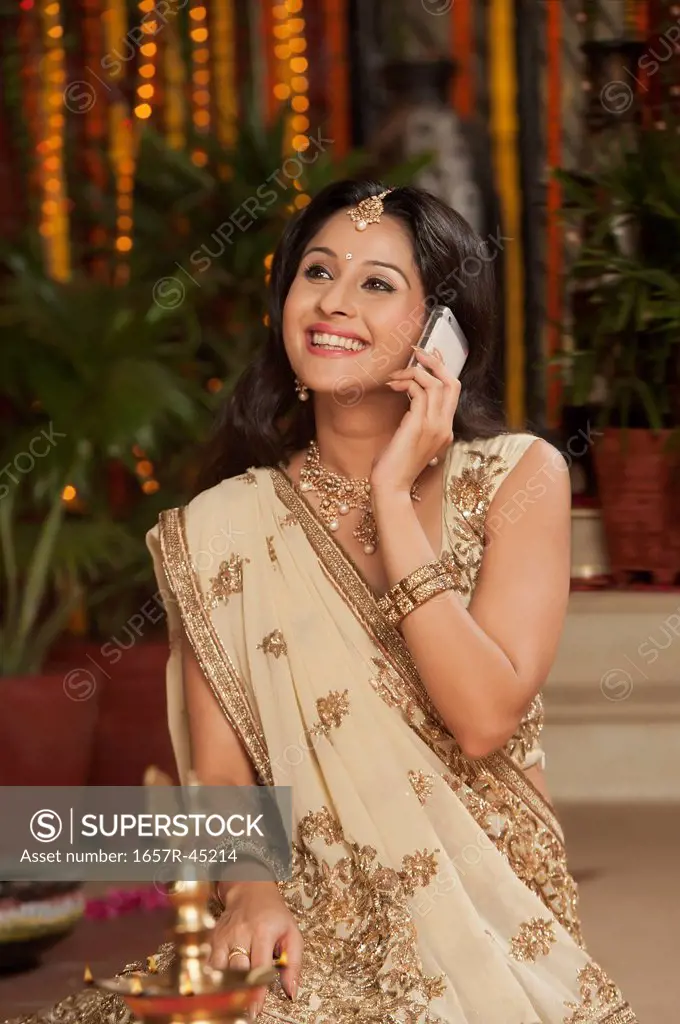 Woman talking on a mobile phone on Diwali
