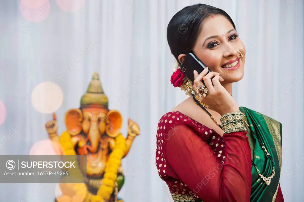 Maharashtrian woman talking on a cell phone during Ganesh Chaturthi festival