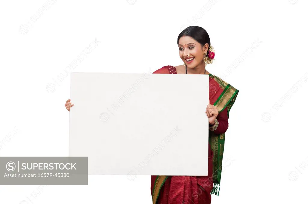 Maharashtrian woman holding a blank placard and smiling