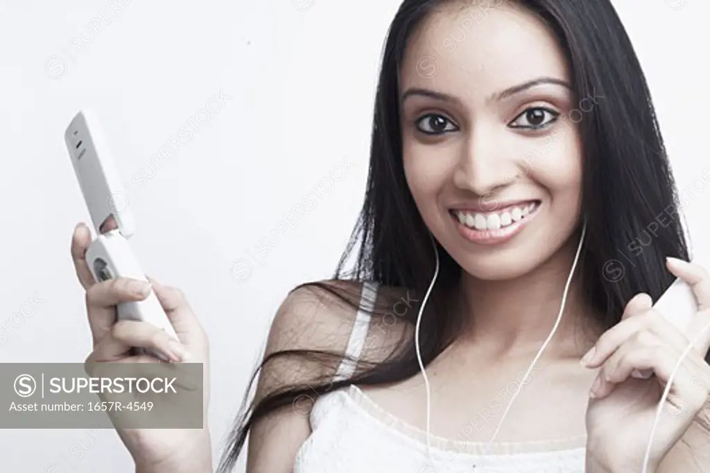 Portrait of a teenage girl holding a mobile phone
