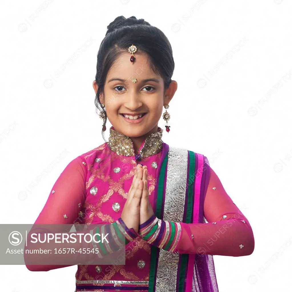 Portrait of a girl imitating like woman greeting on diwali