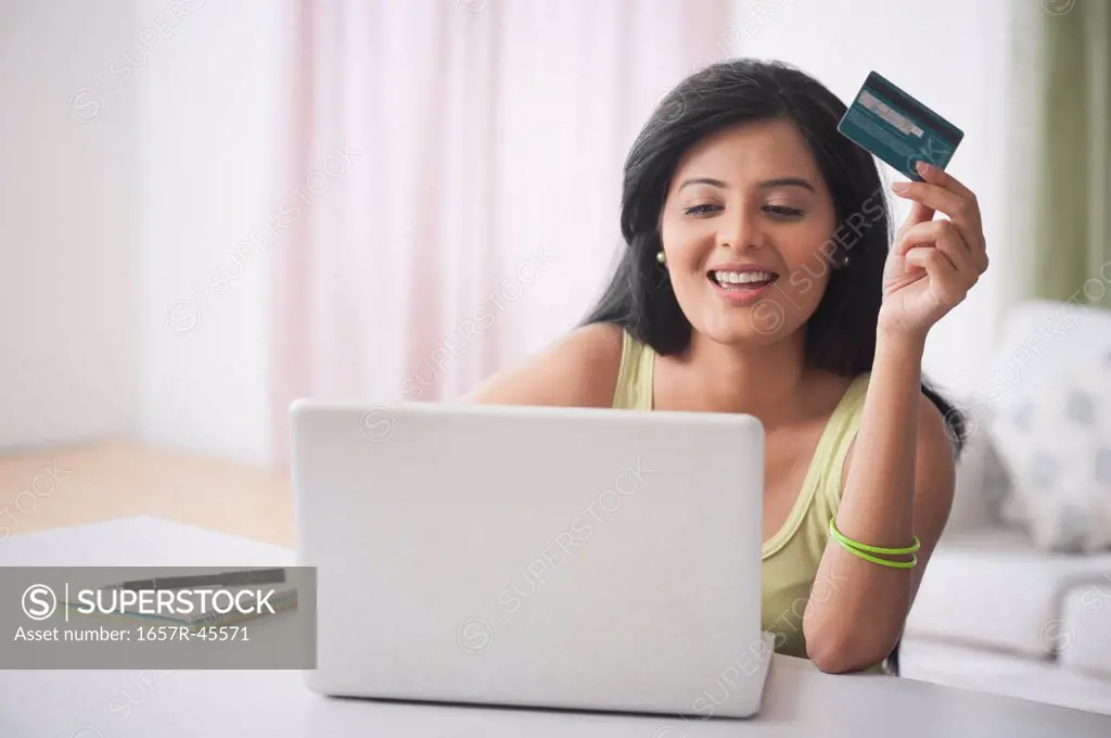Woman doing online shopping with a laptop